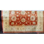 A substantial good quality contemporary wool carpet with a pale terracotta central field