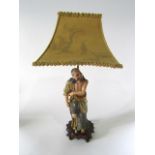 An unusual early 20th century ceramic table lamp in the form of a Japanese style male character in