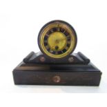 A Victorian black slate and polished marble mantel clock enclosing an eight day timepiece