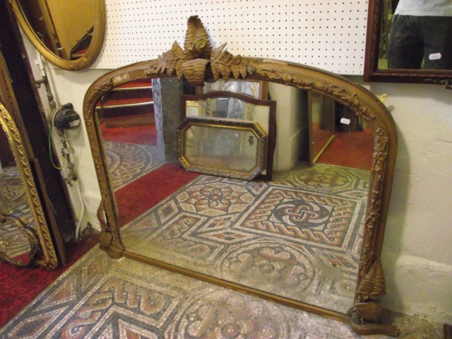 A 19th century overmantel mirror of arched form, the gilt moulded frame with trailing ivy and fern