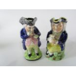 Two 19th century Staffordshire Toby jugs, one in the form of a standing blue jacketed Toby with a