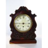 A Regency mahogany mantel clock with shaped case and applied anthemion detail enclosing an eight day