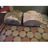 A pair of weathered natural stone pier caps of square cut form with arched outline, 46 cm square