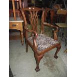 An Edwardian mahogany open elbow chair in the Chippendale style with pierced gothic tracery splat,