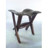 An unusual timber stool, the crossed framework jointed with a rustic stretcher supporting a