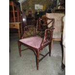 A stained beechwood simulated bamboo framed elbow chair with upholstered pad seat and tapered