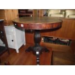 A 19th century mahogany occasional table of circular form raised on a vase shaped reeded pillar