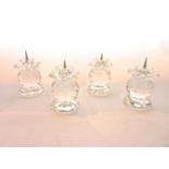 A set of four Swarovski crystal candle stands, each in the form of a faceted globe raised on an