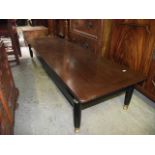 An early G Plan Long John coffee table, the rectangular teak top raised on ebonised supports with