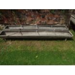 Two similar galvanised steel three rung divisioned feeding troughs of rectangular form, 9ft long