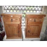 A pair of contemporary Mexican pine bedside cupboards, each enclosed by a panelled door beneath a