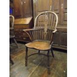 A Windsor elm, ash and beechwood hoop and stick back elbow chair with central pierced wheel splat