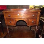 A Regency mahogany bow fronted kneehole side/dressing table with shallow raised three quarter