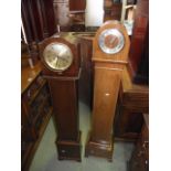 An early 20th century grandmother clock of arched form with walnut veneer case and two train