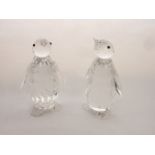 A pair of Swarovski Crystal models of standing penguins, each with all over facet cut detail and