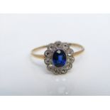 A sapphire and diamond flower head ring, centred with an oval mixed-cut untested sapphire weighing