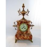 A mid Victorian polished marble mantel clock with applied brass fittings set beneath a shaped urn,