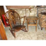 A Ercol dark stained low hoop and stick back rocking chair with central pierced fleur-de-lys