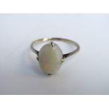 A gem-set ring, probably opal, mounted in white metal, size T 1/2