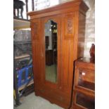 A late Victorian/Edwardian oak three piece bedroom suite comprising a wardrobe, enclosed by a single