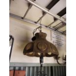 An unusual hanging ceiling light, the scroll work stem supporting a sheet brass shade with