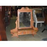 A stripped pine dressing table mirror with rectangular plate and shaped supports incorporating two