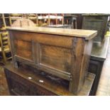 A country made oak and elm coffer with hinged lid, the front elevation with moulded and pegged