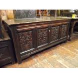 An 18th century oak coffer with hinged lid and moulded panelled frame, the front elevation enclosing