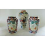 A pair of late 19th century Imari vases tapering cylindrical form each with two polychrome painted