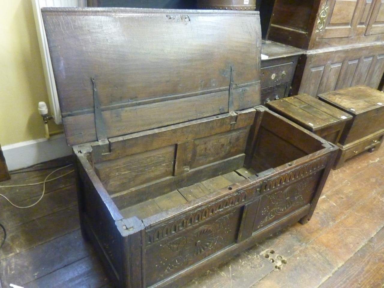 An 18th century oak coffer with hinged lid and panelled frame with moulded and carved detail, 110 cm - Image 2 of 3