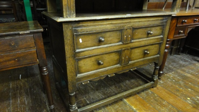 A good quality reproduction oak chest of two long drawers disguised as four small, with moulded