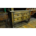 A good quality reproduction oak chest of two long drawers disguised as four small, with moulded