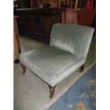 A low Victorian nursing/occasional chair of generous proportions, and upholstered finish, raised