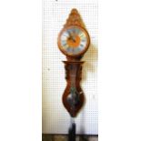 A Continental wall clock, with oak case, silvered chapter ring and carved detail