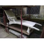 A cream painted wooden adjustable garden lounger with open arms, slatted seat, folding framework and