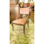 An inlaid Edwardian mahogany occasional chair with pink dralon upholstered seat with serpentine