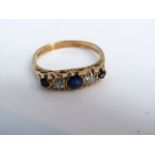An Edwardian style sapphire and diamond ring, set with three round mixed-cut untested sapphires,