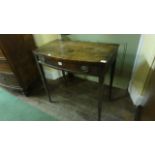 An early 19th century mahogany bow fronted side table with shallow frieze drawer raised on four