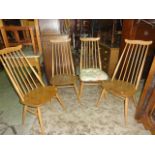 A set of four Ercol light elm and beechwood high stick back dining chairs with cow horn rails and