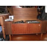 A mid-20th century floorstanding radiogram, the teak case with hinged lid enclosing an Alba radio