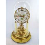 A Kern 400 day or anniversary clock with skeleton movement, painted dial, set beneath a glass dome