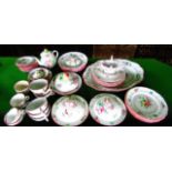 A quantity of French Luneville floral decorated dinner and teawares including an oval meat plate,