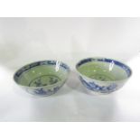 Two 19th century oriental blue and white punch bowls with painted floral insect and rock detail,