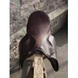 A dark brown leather equestrian saddle