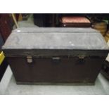 A vintage wooden and fibre clad domed top travelling trunk, the hinged lid lathe bound