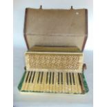 A 20th century cased piano accordion with shellac casing marked Estrella