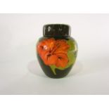 A Moorcroft green ground ginger jar and cover in the coral and hibiscus pattern with painted WM