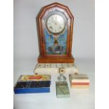 An American type mantle clock of canted arched form with glazed panelled door with painted garland