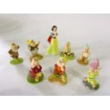 A collection of Royal Doulton figures from the Disney Snow White series comprising Snow White SW9,