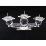 A Swarovski crystal three divisional candle stand in the form of three faceted globes supported on a